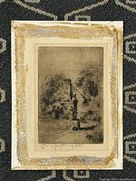 Full framed etching showing the artwork and frame, with visible wear at the borders.