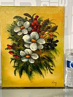 Full view of the floral oil painting on canvas with a yellow background, white flowers, red berries, and green leaves. Shows the entire artwork and signature.