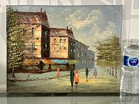 Full view of the signed impressionistic oil painting showing buildings, trees, and figures under a cloudy sky.