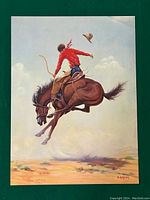 Full view of vintage print showing cowboy in red shirt riding bucking brown horse with hat flying off, desert background.