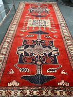 Full view of the rug laid flat, showing overall field, medallion sequence, border and fringe