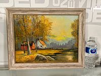 Full view of framed oil painting showing rural landscape with autumn trees, barn, house, and rocks, signed J. Barnes.