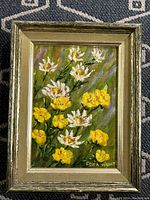 Framed oil on board painting of white and yellow flowers with green background and signature