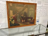 Full view of the framed vintage print featuring two elegant women in period-style dresses inside an ornate interior.