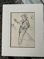 Close-up photo of artwork framed with clear view of charcoal lines and sketch details.