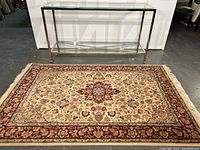 Full view of entire carpet laid flat beneath glass console table