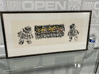 Photo of the full framed print showing the entire artwork and frame alongside a water bottle for scale.