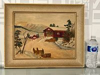Full view of the framed oil painting showing a winter scene with a red covered bridge, horse-drawn sleigh, snow-covered ground, trees, and mountains in the background.