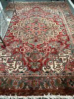 Full view of rectangular rug laid flat showing overall pattern and fringe