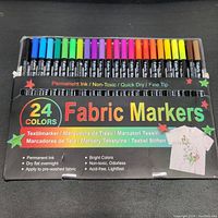 Top-down view of the 24 fabric markers in original packaging showing multiple bright colors.