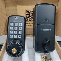 Front panel of AiBOCN smart door lock with keypad and keyhole shown in foam packaging box.