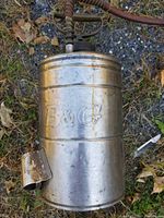 Top down photo of vintage stainless steel B&G sprayer with embossed B&G logo on tank.