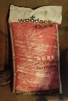 Photo of a large 50-pound bag of Woodacre acidifying fertilizer, showing front label and condition of bag