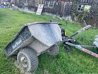 Side view of cart showing metal bed, wheels and overall wear