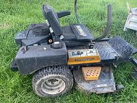 Left side profile of zero-turn mower showing seat, side-discharge deck and left fuel tank