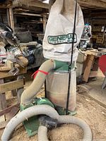 Front view of entire dust collector system showing motor, housing, bags and hoses