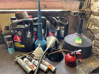 Overall assortment showing funnels, oil containers, small oil can, and grease gun