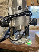 Front view of Craftsman plunge router showing handles, power cord, and base with work light label.