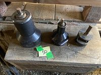 Three tenon cutters of varying sizes arranged side by side on a wooden surface, showing shape and relative size.