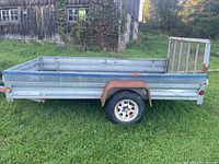 Side profile of entire trailer showing length, side panels, wheel and fender.