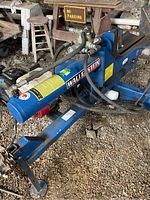 Full side view of blue Wallenstein frame showing hydraulic cylinder, hoses and brand decal