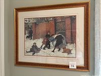 Full view of framed print showing children playing in the snow with a dog, framed in gold-colored frame.