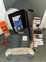 Photo of all items in the lot: Omron BP monitor, moist heating pad box, chair cushion, two canes, hand grips, microwave heat pack.