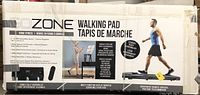Box front of Go Zone Walking Pad showing main features including foldable design, safety features, LCD display, and remote control (remote not included). Photo used to confirm product identity and features.