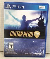Front cover of Guitar Hero Live game case for PS4 showing title, rating, and cover art.