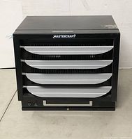 Front view showing black metal housing with silver horizontal airflow louvers and Mastercraft branding.