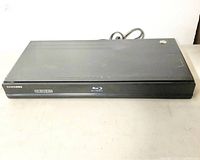 Samsung Blu-Ray Disc Player top and front view showing overall condition with minor surface wear.