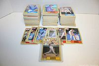 Photo showing three stacks of 1987 OPC baseball cards with several individual cards displayed in front including the Barry Bonds rookie card in protective plastic.