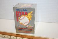 Front view of the sealed 1991 Nolan Ryan trading card box showing artwork of a flaming baseball and branding information.
