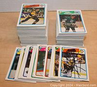 Two stacks of NHL hockey cards from the 1988-1990 O-Pee-Chee series plus a few loose cards with one heavily marked.