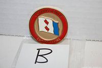 Front of challenge coin showing Commissioner title and Canadian flag with maple leaves and blue segment.