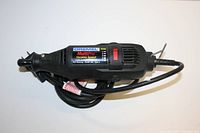 Photo showing side view of black Dremel MultiPro variable speed rotary tool model 395 with power cord coiled.