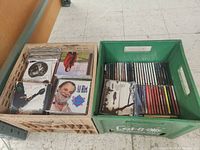 Photo of two crates filled with CDs, showing covers and cases