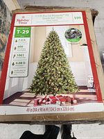 Box showing front label of the Holiday Time 7.5 foot Pre-Lit Kennedy Fir artificial Christmas tree with product details and image of tree.