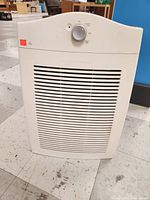Front view of the white Hamilton Beach air purifier showing vertical rectangular shape and front air intake vents.