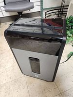 Front-side view of Tru Red paper shredder showing transparent window and unit shape.