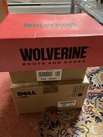 Red Wolverine Boots and Shoes box on top of a Dell box. The box is labeled with product codes.