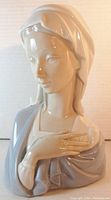 Front view of the Lladro Madonna bust figurine showing facial features and hand placement.