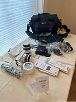 Overview of Nikon camera, lenses, bag and accessories on table