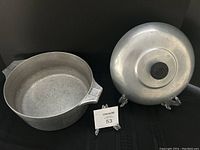 Aluminum pot and lid side by side, showing both items in the lot