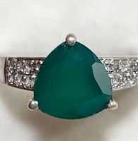 Close-up of the green onyx stone and cubic zirconia accents on the silver ring band.