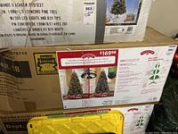 Box of 7.5 ft pre-lit Norwich spruce artificial Christmas tree showing brand and product details