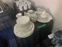 Full set of Royal Doulton Avignon china items arranged showing stacks of plates, cups, and serving pieces.