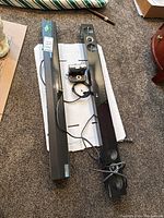 Two LG sound bars flat on carpet: one longer and one shorter, model and connections visible on underside.