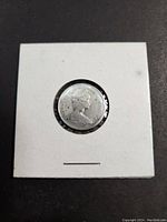 Front side of 1965 Canadian silver dime in coin holder showing Queen Elizabeth II profile.