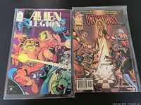 Two vintage independent sci-fi comic books: Alien Legion #4 from 1988 and Ultraforce #9 from 1996 side by side on a flat surface.